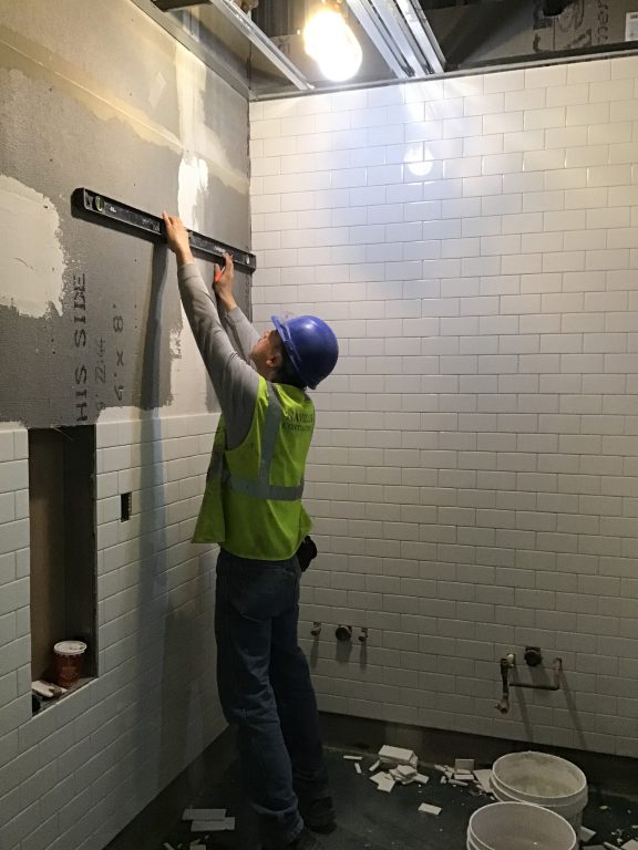 Tile finishes being installed in the back of house area of the future LIRR passenger concourse 04-12-19